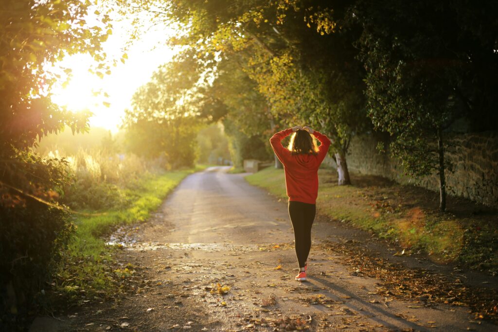 woman running on natural path