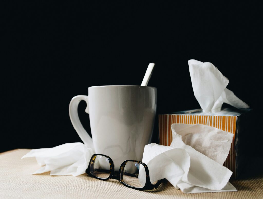 tissue box, tea, and glasses on a table