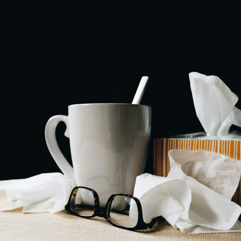 tissue box, tea, and glasses on a table