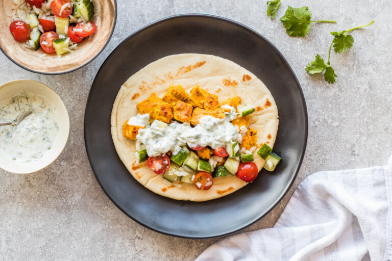 Chicken tikka naan wrap on plate on table