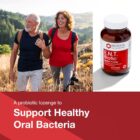 An older man and woman smile while hiking outdoors, next to a bottle of E.N.T. Biotic™. Text: A probiotic lozenge for supporting healthy oral bacteria.