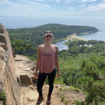 Emily Dunkley, registered dietitian nutritionist, standing outside on top of a mountain